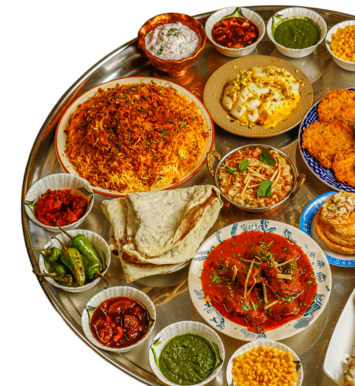 A traditional Bohri thali platter with biryani, kebabs, samosas, raan, chutneys, and condiments